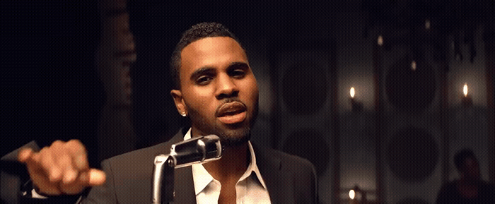 a man in a suit holding a microphone