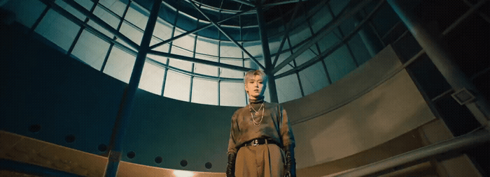a mannequin is standing in a room with a round window