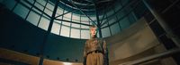 a mannequin is standing in a room with a round window