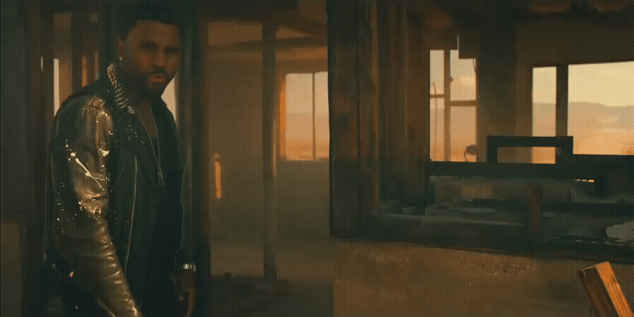 a man standing in a room next to a window