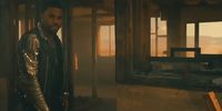 a man standing in a room next to a window