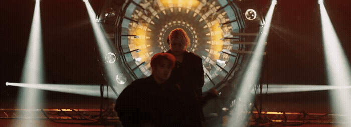a couple of people standing in front of a ferris wheel