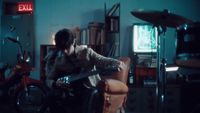 a man sitting in a chair with a guitar