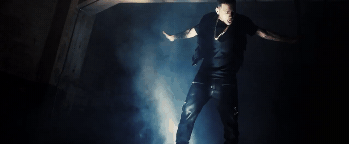 a man standing on a stage with his arms outstretched