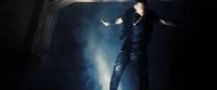 a man standing on a stage with his arms outstretched