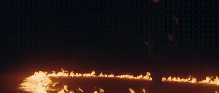 a man standing in front of a lot of fire