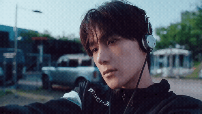a man wearing headphones and a black jacket