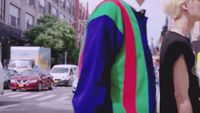 a man and a woman walking down a street