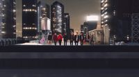 a group of people standing on top of a roof