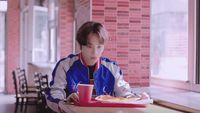 a person sitting at a table with a plate of food