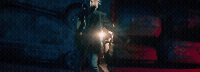 a woman walking down a street at night