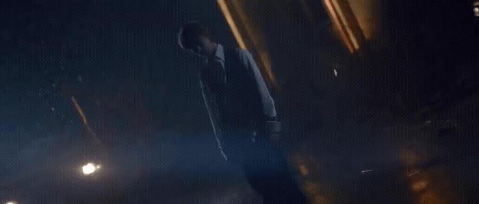 a man walking down a street at night