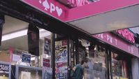 a man is standing outside of a store