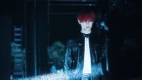 a man with red hair wearing a black jacket and tie