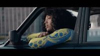 a woman sitting in the passenger seat of a car