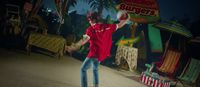 a man in a red shirt throwing a frisbee