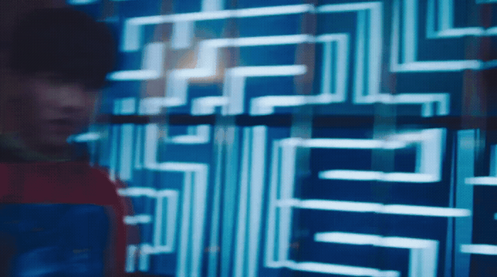 a man standing in front of a blue wall