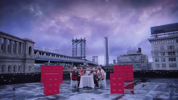 a group of people sitting at a table on a roof