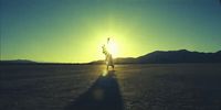 a person standing in the middle of a desert