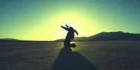 a person standing in the middle of a desert