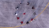 a group of people walking across a parking lot