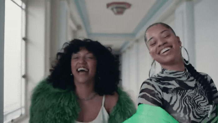 a man and a woman laughing in a hallway