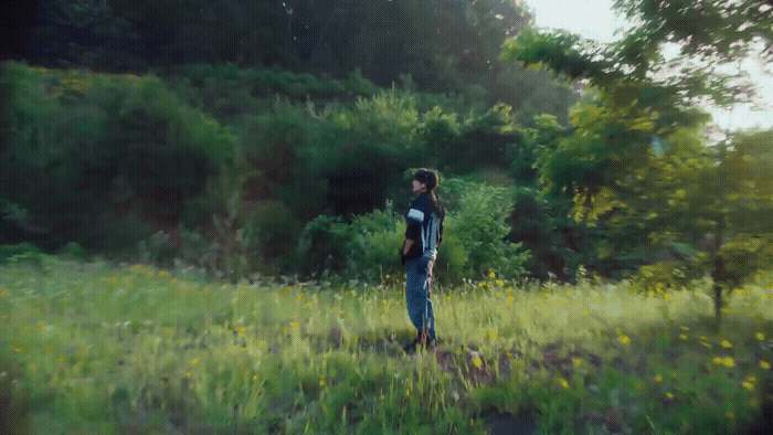 a man standing in a field of tall grass