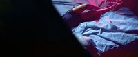 a bed with a blue comforter and a red blanket