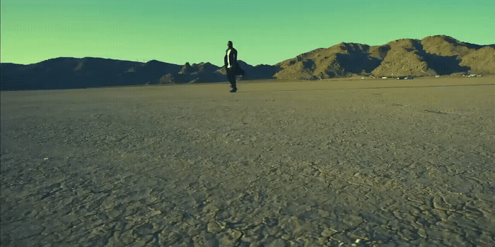 a person standing in the middle of a desert