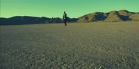 a person standing in the middle of a desert