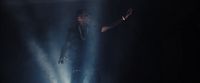 a man standing on a stage with his arms outstretched