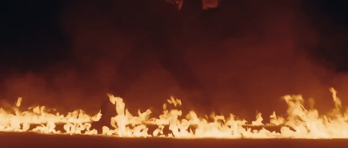 a large fire is burning in the dark