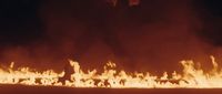 a large fire is burning in the dark