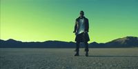 a man standing in the middle of a desert