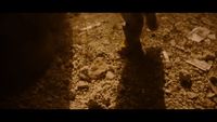 a blurry photo of a person walking in the dirt