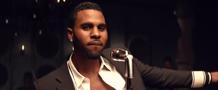 a man in a suit holding a microphone
