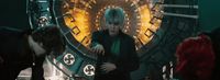a person standing in front of a clock in a room