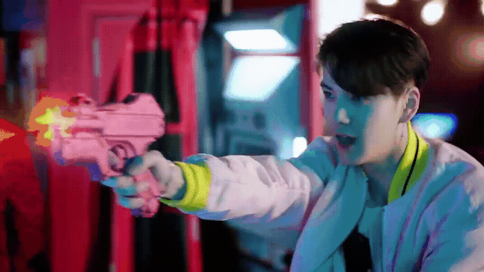 a young man holding a toy gun in his hand