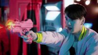 a young man holding a toy gun in his hand