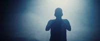 a silhouette of a person standing in front of a light
