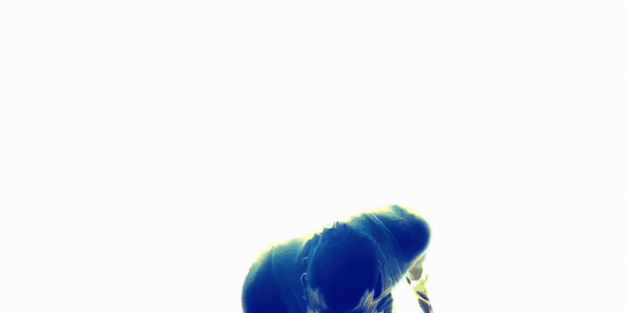 a blue bird is sitting on the ground