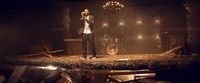 a man standing on top of a stage holding a microphone
