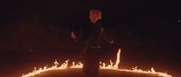 a man standing in a circle of fire