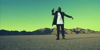 a man standing in the middle of a desert