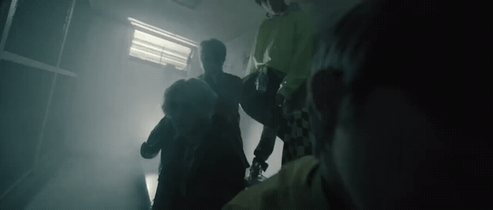 a group of people standing in a dark room