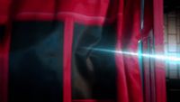 a close up of a red curtain with a light shining through it