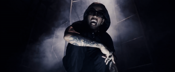 a man in a black hoodie with his mouth open