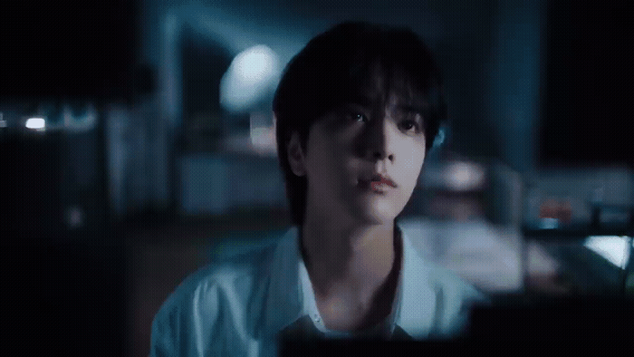 a man in a white shirt is staring at something