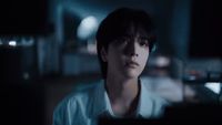 a man in a white shirt is staring at something