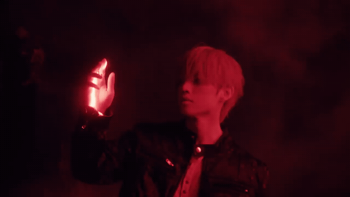 a young man holding a glowing object in his hand